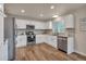 Bright kitchen with stainless steel appliances, white cabinets, and modern backsplash at 9884 Sydney Ln, Highlands Ranch, CO 80130