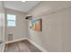 Bright laundry area with overhead shelving and an artistic touch offers efficient space at 9884 Sydney Ln, Highlands Ranch, CO 80130
