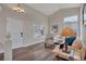 Open-concept living room with wood floors, high ceilings, and comfortable white seating near the entry at 9884 Sydney Ln, Highlands Ranch, CO 80130