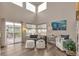 Bright living room with vaulted ceilings, large windows, and access to outdoor deck at 9884 Sydney Ln, Highlands Ranch, CO 80130