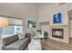 Comfortable living room with a fireplace, modern furniture, and cozy decor at 9884 Sydney Ln, Highlands Ranch, CO 80130