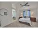 Main bedroom boasts neutral colors, ceiling fan, and ensuite bathroom access for a peaceful retreat at 9884 Sydney Ln, Highlands Ranch, CO 80130