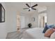 Spacious main bedroom with ceiling fan, ensuite access, and closet entrance creates a private oasis at 9884 Sydney Ln, Highlands Ranch, CO 80130
