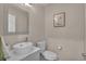 Stylish powder room features a modern vessel sink, decorative mirror, and convenient toilet at 9884 Sydney Ln, Highlands Ranch, CO 80130