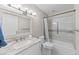 Updated bathroom with a shower/tub combo, granite vanity, and modern fixtures at 595 S Alton Way # 5D, Denver, CO 80247