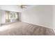 Spacious bedroom with neutral walls, carpet flooring, and ceiling fan at 595 S Alton Way # 5D, Denver, CO 80247