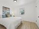 Cozy bedroom with a queen size bed, simple decor, and ample natural light from a nearby window at 2120 Oak Pl, Thornton, CO 80229