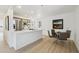 Modern kitchen and dining area with stainless steel appliances, sleek countertops, and open shelving for storage at 2120 Oak Pl, Thornton, CO 80229