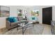 Inviting living room with neutral tones, large windows, and comfortable seating, complete with contemporary design elements at 2120 Oak Pl, Thornton, CO 80229