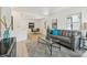 Bright living area with modern decor, light wood floors, and stylish furniture arrangement and ample natural light at 2120 Oak Pl, Thornton, CO 80229