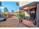 Back porch with brick floor, outdoor seating, and grill, perfect for outdoor relaxation and entertaining at 8737 Garrison Ct, Arvada, CO 80005
