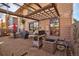 Back patio featuring a trellis, grill, patio furniture, and brick flooring at 8737 Garrison Ct, Arvada, CO 80005