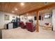 Finished basement with wooden ceilings, track lighting, and comfortable seating at 8737 Garrison Ct, Arvada, CO 80005