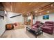 Spacious basement featuring wood ceilings, comfortable seating and track lighting at 8737 Garrison Ct, Arvada, CO 80005