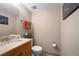 Compact half bathroom featuring neutral tones, tile floor, and a classic design at 8737 Garrison Ct, Arvada, CO 80005
