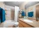 Well-lit bathroom with a shower and tub combination, modern fixtures, and plenty of storage space at 8737 Garrison Ct, Arvada, CO 80005