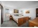 Bright bedroom featuring natural wood furniture, large windows, and a calming atmosphere at 8737 Garrison Ct, Arvada, CO 80005