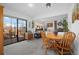 Open-concept space with dining area, slider to the patio, seamless access to living area with fireplace at 8737 Garrison Ct, Arvada, CO 80005