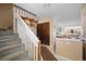 Cozy entryway with stairs, coat closet, and seamless transition to the inviting living space at 8737 Garrison Ct, Arvada, CO 80005