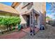 Inviting front porch with brick flooring and decor, offering a cozy welcome at 8737 Garrison Ct, Arvada, CO 80005