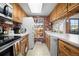 Bright kitchen with brick accents, white countertops, oak cabinets, and functional appliances at 8737 Garrison Ct, Arvada, CO 80005