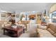 Spacious living room showcasing an open floor plan, comfortable furnishings, and seamless flow to the kitchen at 8737 Garrison Ct, Arvada, CO 80005