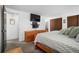 Comfortable bedroom with a dresser, TV, and a peek into the ensuite bathroom at 8737 Garrison Ct, Arvada, CO 80005