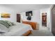 Serene bedroom with TV, wood furniture, and access to a charmingly paneled bathroom at 8737 Garrison Ct, Arvada, CO 80005