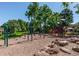 Community playground area featuring swings, climbing structures, and soft landing surfaces at 8737 Garrison Ct, Arvada, CO 80005