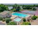 Aerial view of a community pool and tennis courts with lush greenery and scenic views at 8737 Garrison Ct, Arvada, CO 80005