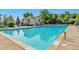 Community swimming pool with lounge chairs and a well-maintained pool house at 8737 Garrison Ct, Arvada, CO 80005