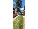 Townhome exterior view with green grass, wooden fence, blue sky, and nearby parking at 2355 E Geddes Ave # G24, Centennial, CO 80122