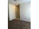 Neutral hallway leading to front door with neutral carpet at 2355 E Geddes Ave # G24, Centennial, CO 80122