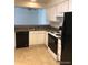 Well-lit kitchen featuring white cabinets, black appliances, and an open layout at 2355 E Geddes Ave # G24, Centennial, CO 80122