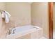 A luxurious soaking tub is set within tan tile, offering a serene, spa-like experience at 1521 Ski Hill Rd # 8313, Breckenridge, CO 80424