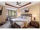 Cozy bedroom features wood-framed bed, ceiling fan, and view to the outside at 1521 Ski Hill Rd # 8313, Breckenridge, CO 80424