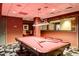 Billiards room with a red pool table, overhead lighting, and decorative accents at 1521 Ski Hill Rd # 8313, Breckenridge, CO 80424