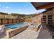 Outdoor hot tub with stone surround and mountain views in the background at 1521 Ski Hill Rd # 8313, Breckenridge, CO 80424
