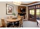 Cozy living area featuring a fireplace, dining set, and balcony access with scenic views at 1521 Ski Hill Rd # 8313, Breckenridge, CO 80424