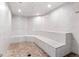 Bright steam room featuring marble tiled walls, stone floor, and built-in bench seating at 1521 Ski Hill Rd # 8313, Breckenridge, CO 80424