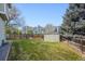Fenced-in backyard featuring lush green lawn and convenient shed, providing secure storage and outdoor space at 8229 S Ogden Cir, Littleton, CO 80122