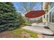 Landscaped backyard featuring concrete patio, mature trees, and a well-manicured lawn at 8229 S Ogden Cir, Littleton, CO 80122