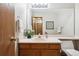 Cozy bathroom featuring a vanity with sink and mirror, complemented by fresh towels and greenery at 8229 S Ogden Cir, Littleton, CO 80122