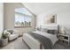 Comfortable bedroom with a large window, a cozy chair, and soft, neutral tones at 8229 S Ogden Cir, Littleton, CO 80122