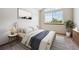 Bright bedroom featuring a large window, a comfortable bed, and stylish decor at 8229 S Ogden Cir, Littleton, CO 80122