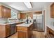 Functional kitchen features wood cabinets, granite countertops, and stainless-steel appliances at 8229 S Ogden Cir, Littleton, CO 80122