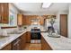 Well-equipped kitchen with stainless steel appliances, island, and wood cabinets at 8229 S Ogden Cir, Littleton, CO 80122