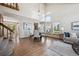 Open concept dining room and living room with large windows and hardwood floors at 8229 S Ogden Cir, Littleton, CO 80122