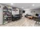 Open basement area featuring a piano, shelving, and comfortable seating, perfect for a Gathering room or entertainment space at 400 W Midway Blvd, Broomfield, CO 80020