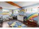 Whimsical bedroom with rainbow mural, hardwood floors, and plenty of space to play and create at 400 W Midway Blvd, Broomfield, CO 80020